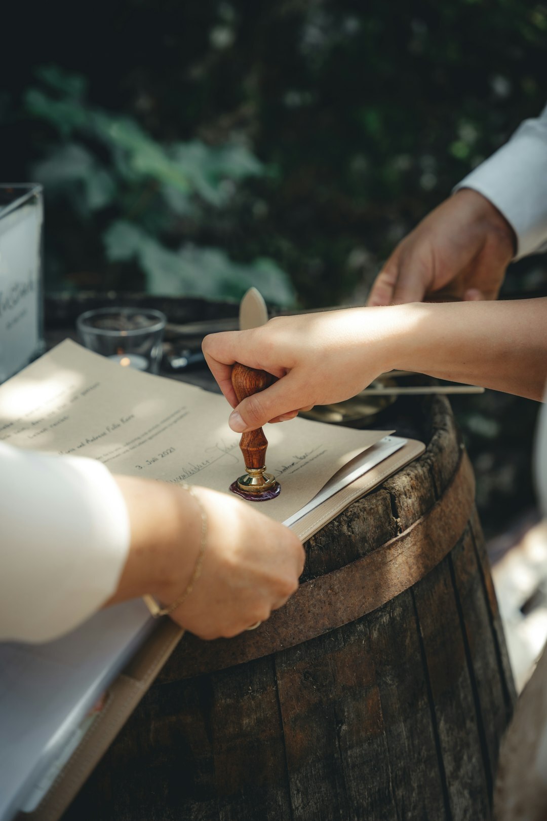 Notary stamping and sealing an official document on a wooden desk