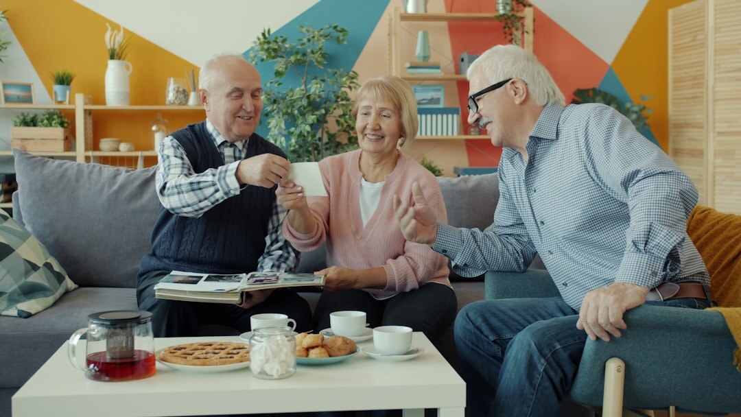 Senior Turkish couple shaking hands with a legal advisor across a desk